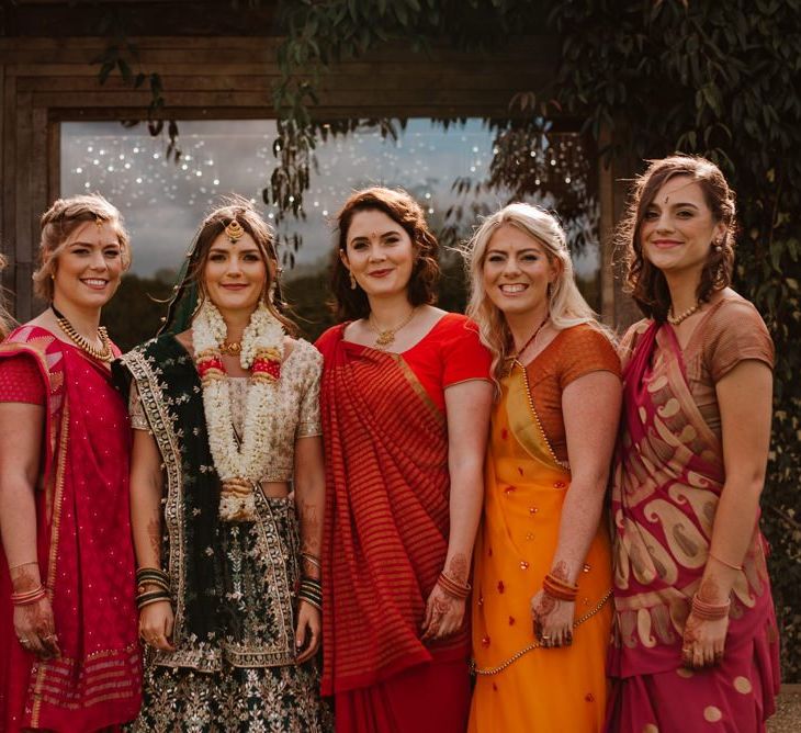 Bride and bridesmaids in colourful Indian sari's for Hindu and  civil wedding ceremony