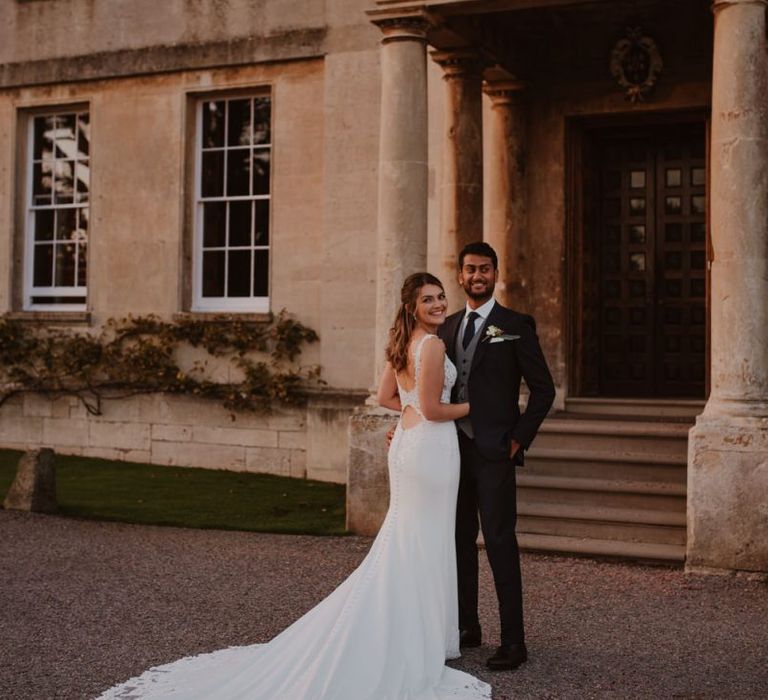 Bride in Maggie Sottero Kelset wedding dress with lace edge long train