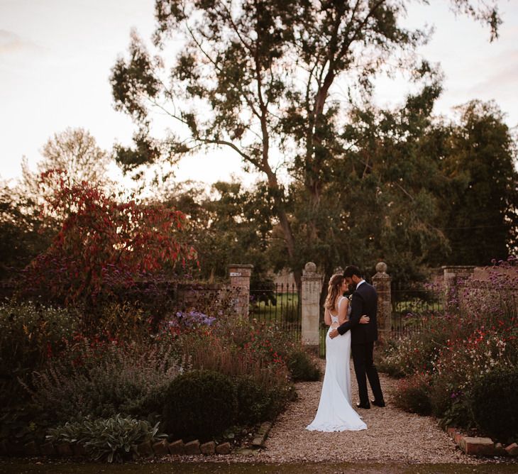 Bride and groom portrait in Elmore court gardens