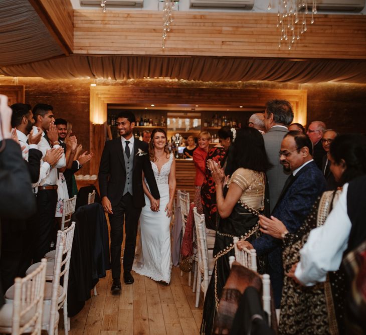 Bride and groom entering the wedding reception