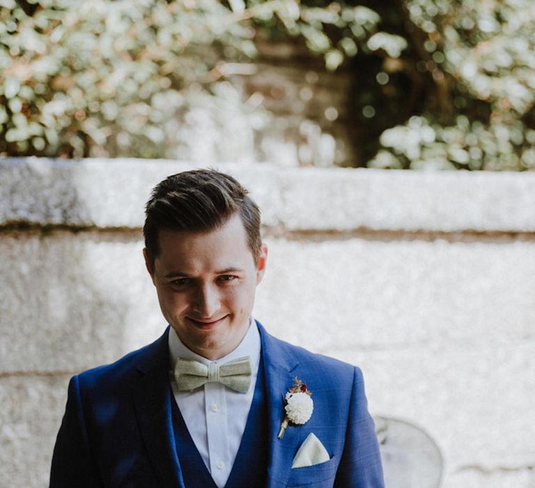 Groom in Hawes and Curtis Navy Suit &amp; Bow Tie | Outdoor Cornish Wedding at Boconnoc Estate | Nick Walker Photography