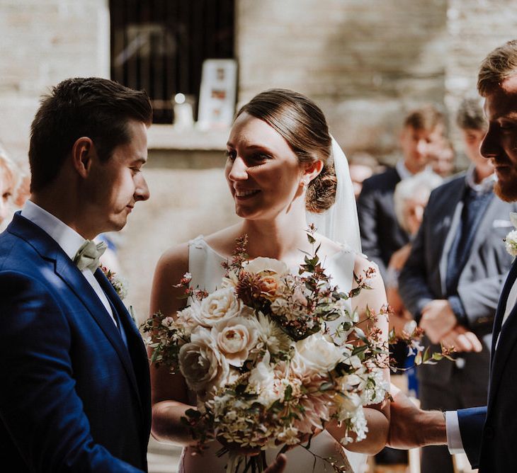 Wedding Ceremony | Bride in Lace Back Pronovias Wedding Dress | Groom in Hawes and Curtis Navy Suit &amp; Bow Tie | Outdoor Cornish Wedding at Boconnoc Estate | Nick Walker Photography