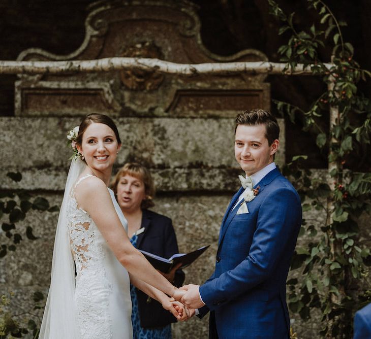 Wedding Ceremony | Bride in Lace Back Pronovias Wedding Dress | Groom in Hawes and Curtis Navy Suit &amp; Bow Tie | Outdoor Cornish Wedding at Boconnoc Estate | Nick Walker Photography