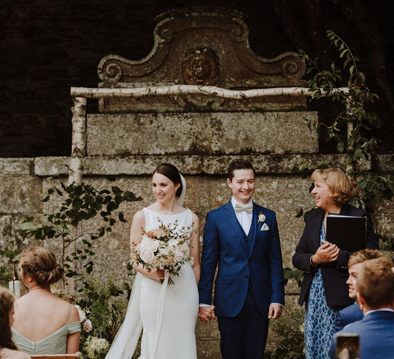 Wedding Ceremony | Bride in Lace Back Pronovias Wedding Dress | Groom in Hawes and Curtis Navy Suit &amp; Bow Tie | Outdoor Cornish Wedding at Boconnoc Estate | Nick Walker Photography