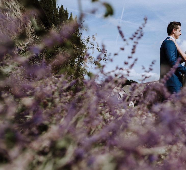 Bride in Lace Back Pronovias Wedding Dress | Groom in Hawes and Curtis Navy Suit &amp; Bow Tie | Outdoor Cornish Wedding at Boconnoc Estate | Nick Walker Photography