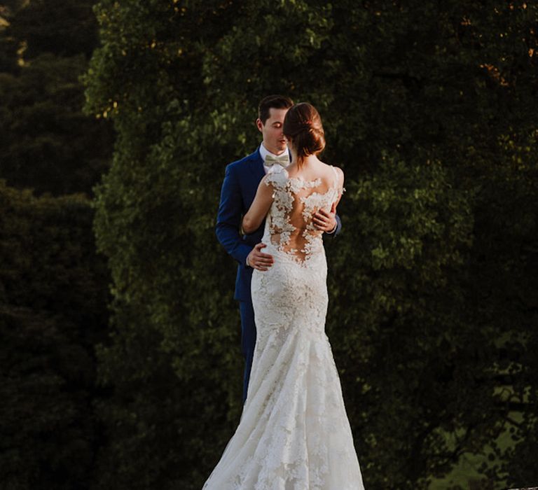 Bride in Lace Back Pronovias Wedding Dress | Groom in Hawes and Curtis Navy Suit &amp; Bow Tie | Outdoor Cornish Wedding at Boconnoc Estate | Nick Walker Photography