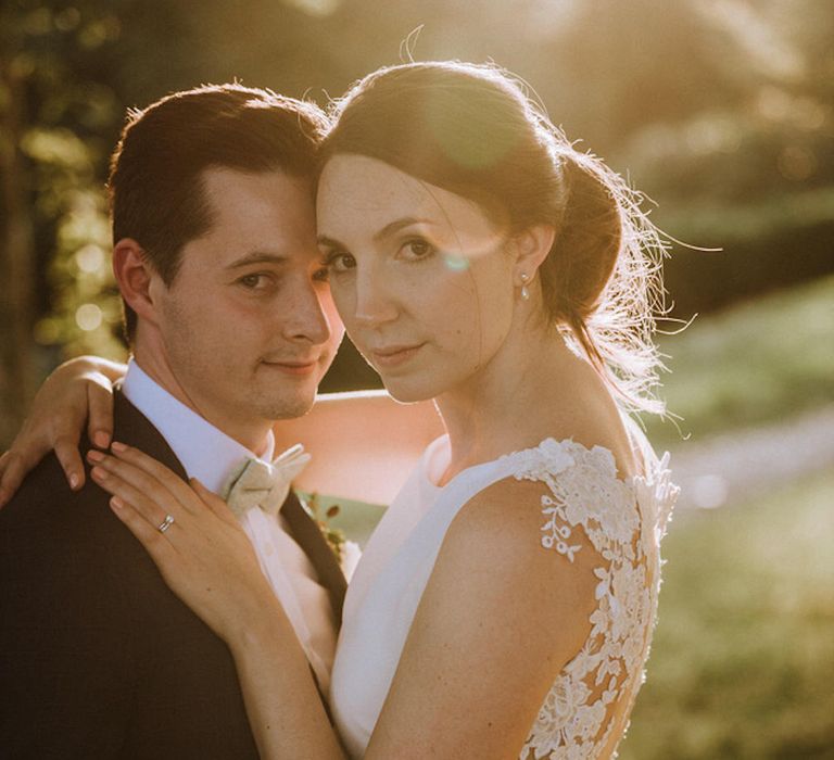 Bride in Lace Back Pronovias Wedding Dress | Groom in Hawes and Curtis Navy Suit &amp; Bow Tie | Outdoor Cornish Wedding at Boconnoc Estate | Nick Walker Photography