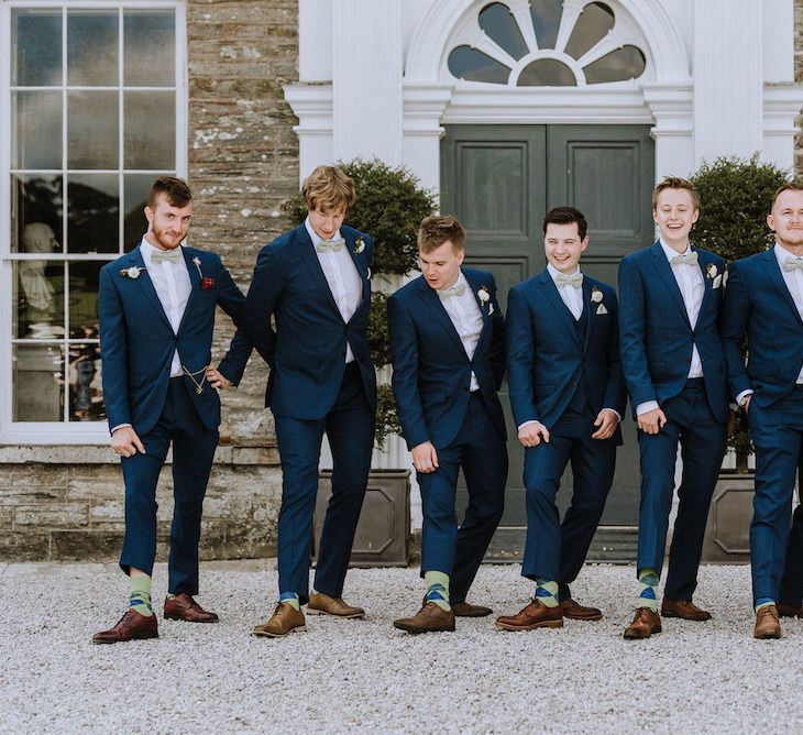 Groomsmen in Hawes and Curtis Navy Suits &amp; Bow Ties | Outdoor Cornish Wedding at Boconnoc Estate | Nick Walker Photography