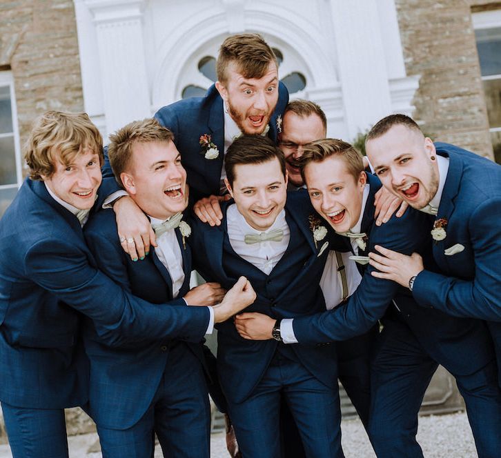 Groomsmen in Hawes and Curtis Navy Suits &amp; Bow Ties | Outdoor Cornish Wedding at Boconnoc Estate | Nick Walker Photography