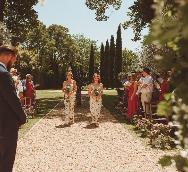 Bridesmaids Walk Down The Aisle For Outdoor Wedding