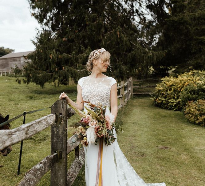 Bride in Rime Arodaky wedding dress with embroidered flower detail