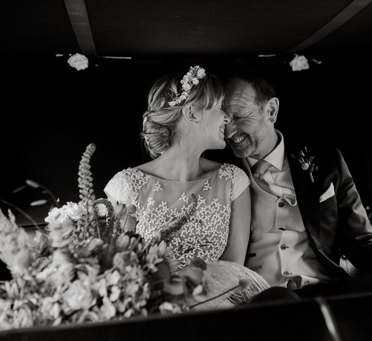 Father of the bride and daughter in the classic wedding car