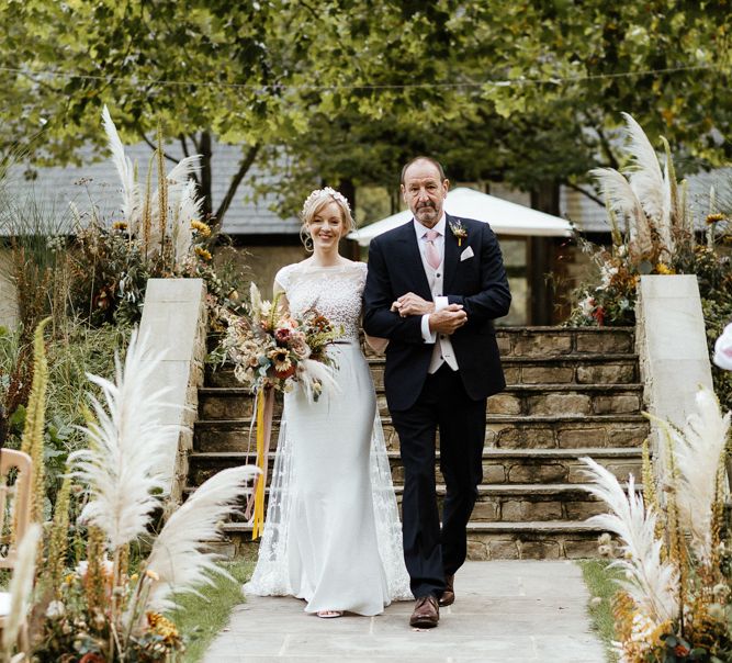 Outdoor ceremony bridal entrance in Rime Arodaky wedding dress