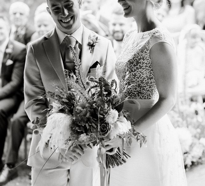 Black and white portrait of the bride and groom exchanging vows