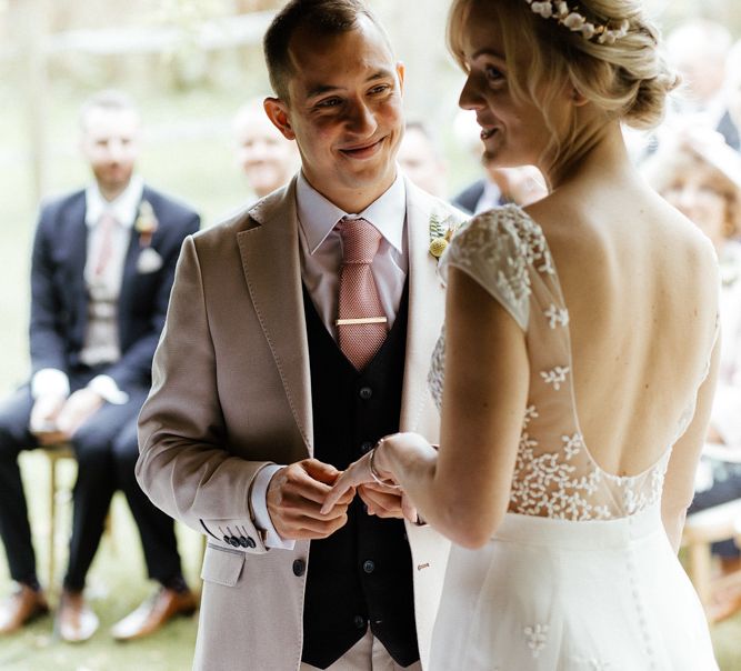 Bride and groom exchanging rings at wedding ceremony