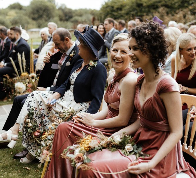 Bridesmaids in pink velvet dresses