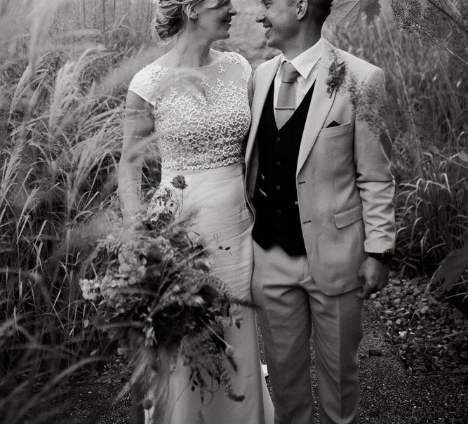 Black and white portrait of the bride and groom in the fields with bride in Rime Arodaky dress