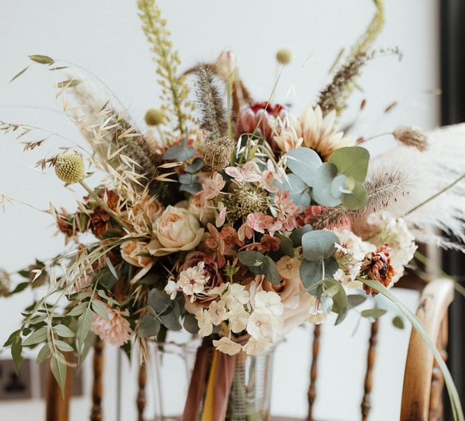 Romantic boho wedding bouquet with dried grasses