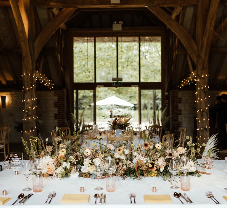 Top table wedding flowers at Bury Court Barn reception