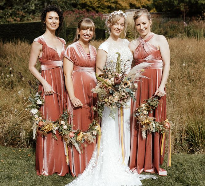 Bridal party portrait with bride in Rime Arodaky gown and bridesmaids in pink velvet dresses