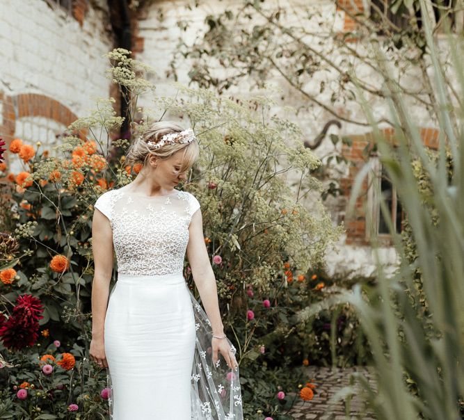 Bride in embroidered Rime Arodaky wedding dress with detailed bodice and train