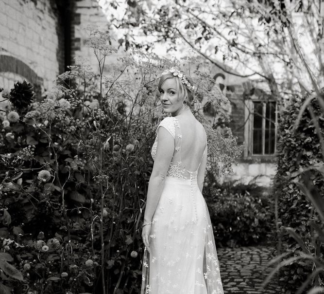 Bride in backless Rime Arodaky wedding dress with embroidered train