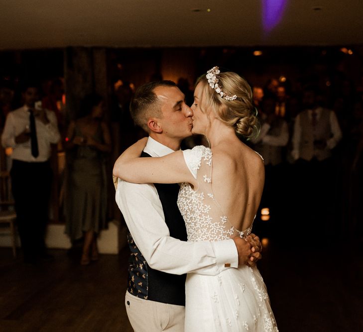 Bride and groom kissing during first dance at Bury Court Barn