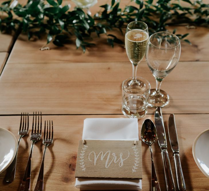 Wedding Table Place Setting With Foliage and White Flowers