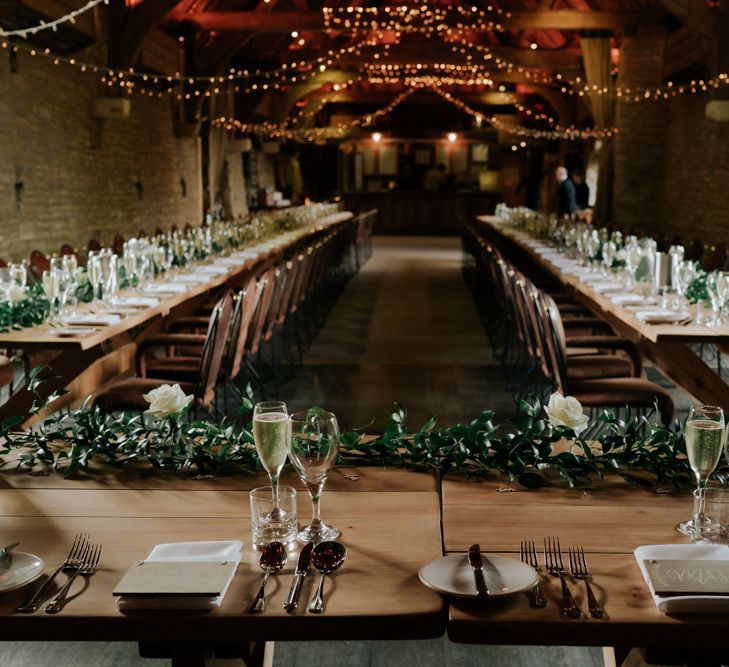 Tythe Barn Wedding Decor With White Flowers and Fairylights