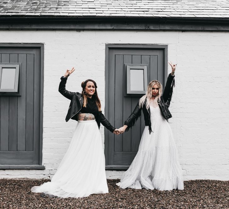 Same-sex brides in a back and white dress, separates and leather jackets