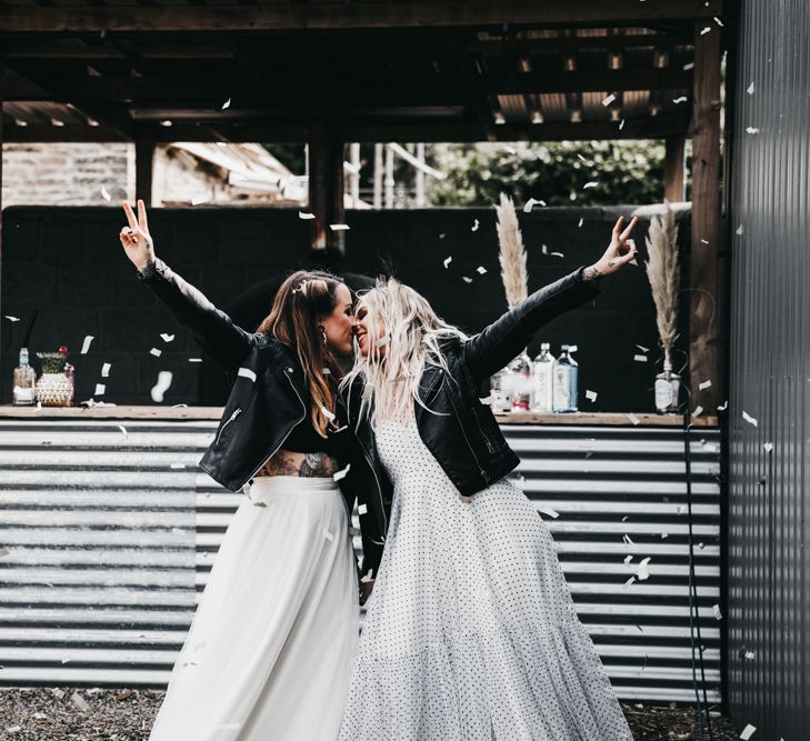 Rock n roll brides kissing at The Drovers wedding venue