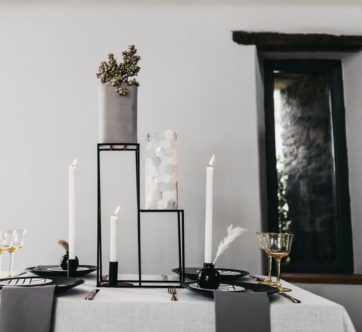 Intimate black and white table decor with wedding cake centrepiece