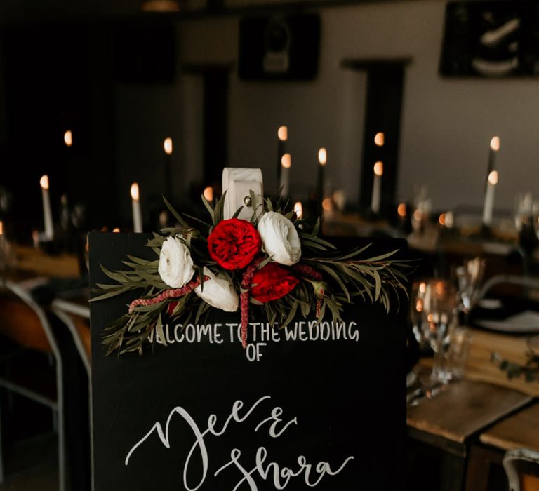 Black Wedding Welcome Sign with White Font and Red &amp; White Floral Decor