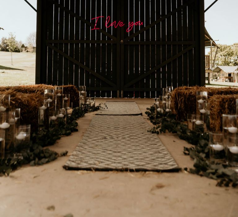 Barn Wedding Ceremony with Hay Bales and Pink Neon I Love You Sign