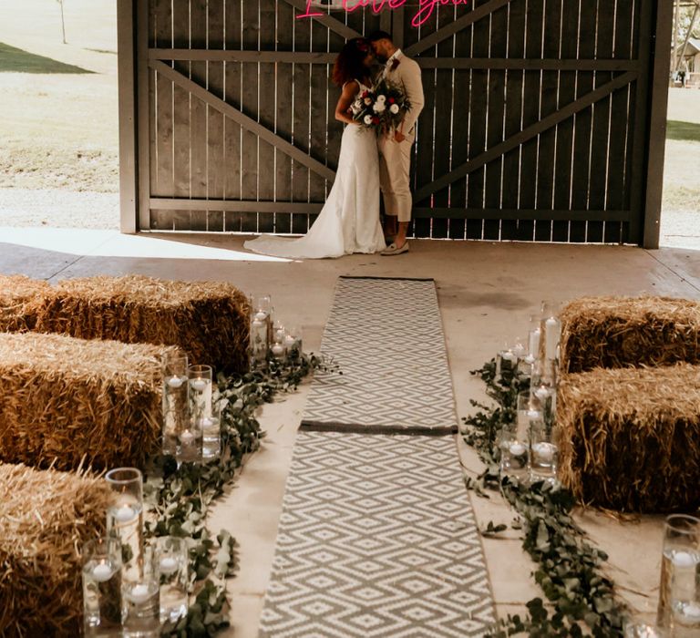 Black Bride with Afro Hair in a Lace Wedding Dress and Groom in Blazer and Loafers Standing at the Wedding Ceremony Altar