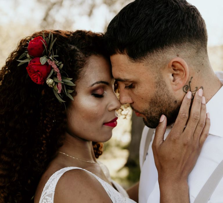 Black Bride with Afro Hair and Fresh Fresh Flowers in a Lace Wedding Dress Being intimate with her Groom