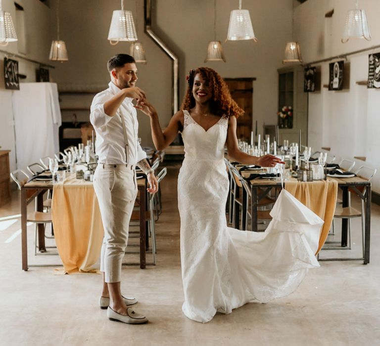 Black Bride in Lace Wedding Dress Being Twirled by Her Groom in  Skinny Trouser, White Shirt &amp; Loafers