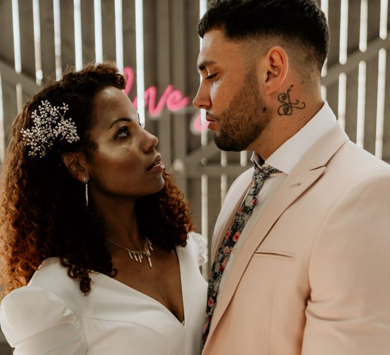 Black Bride with Afro Hair and Cheek Highlighter and Groom in Pink Blazer and Floral Tie