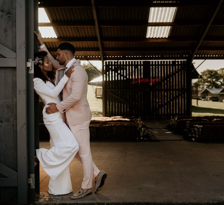 Black Bride with Afro Hair and Cheek Highlighter and Groom in Pink Suit and Floral Tie