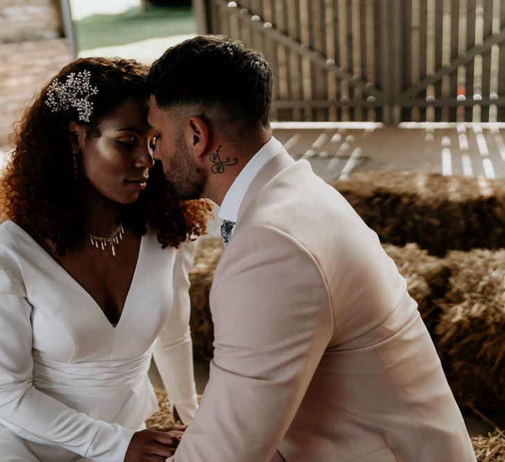 Black Bride with Afro Hair in Jumpsuit and Groom in Pink Blazer