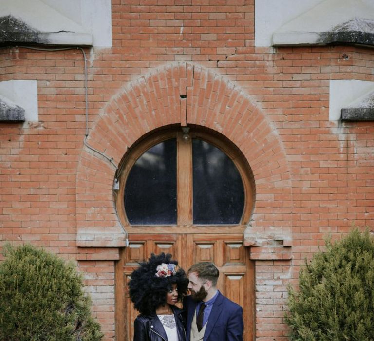 Stylish black bride with afro hair and leather jacket