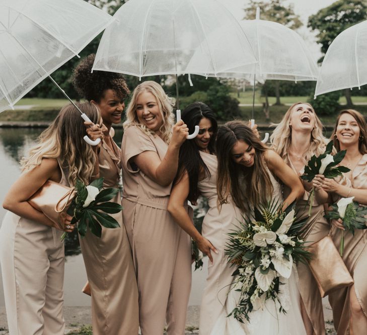 Stylish bridal party portrait under umbrellas