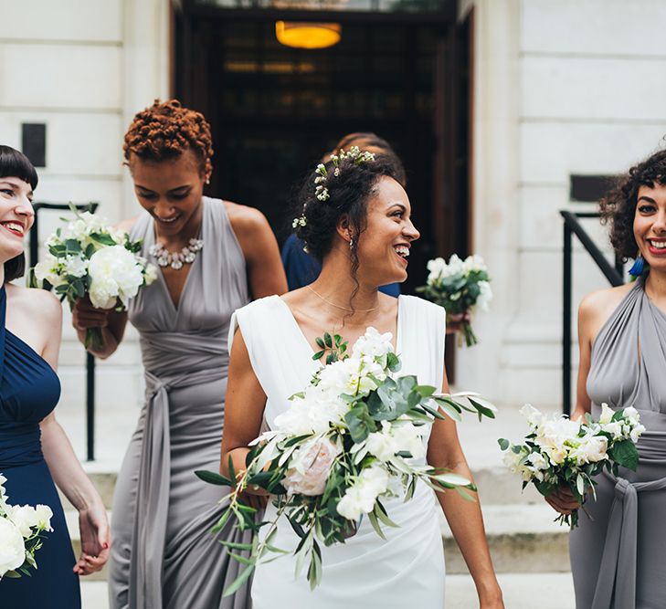 Black bride with flowers in her hair at city wedding