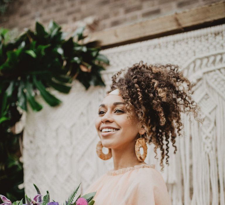 Black bride with curly hair tied in head scarf