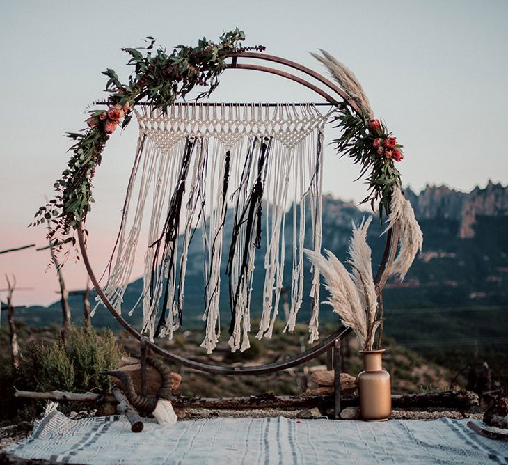 Steel Moon Gate Decorated with Macrame, Red Flowers, Foliage and Pampas Grass