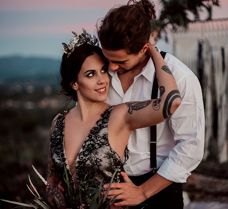 Bride in Antonia Serena Atelier Wedding Dress Embracing Groom in White Shirt and Braces