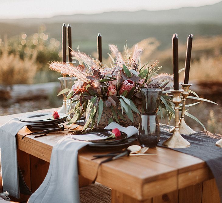 Intimate Table Decor with Gold Candle Sticks Black Taper Candles and Deep Red Floral Centrepiece