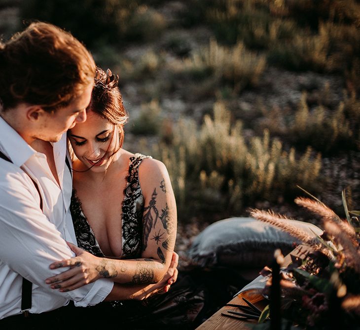 Bride and Groom Embracing at Sweetheart Table