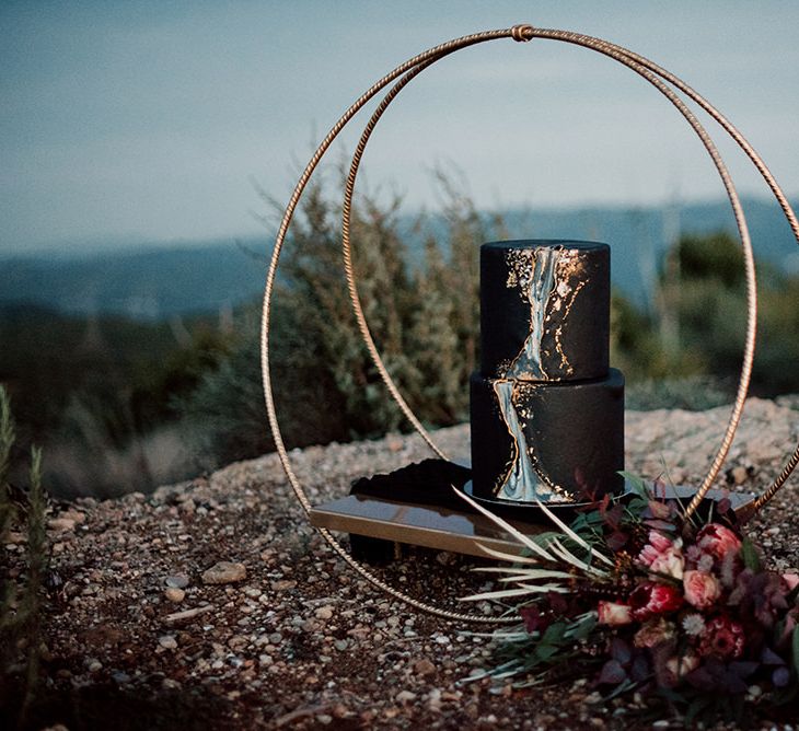 Black Wedding Cake with Front Marble Detail on Circular Hoop Cake Stand