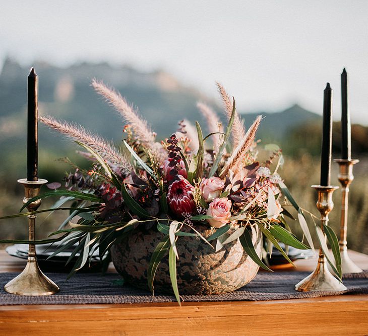 Sweetheart Table Decor with Gold Candle Sticks Black Taper Candles and Deep Red Floral Centrepiece